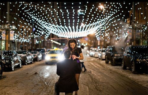 New Years Eve Proposal in a romantic city atmosphere with holiday lights